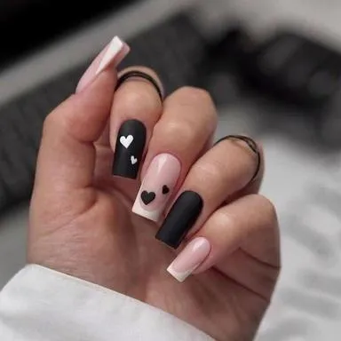 Matte black and nude nails with little hearts