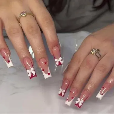 White French tips with red hearts and bows