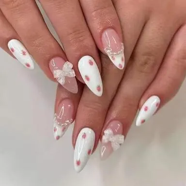 White almond nails with pink dots and bows